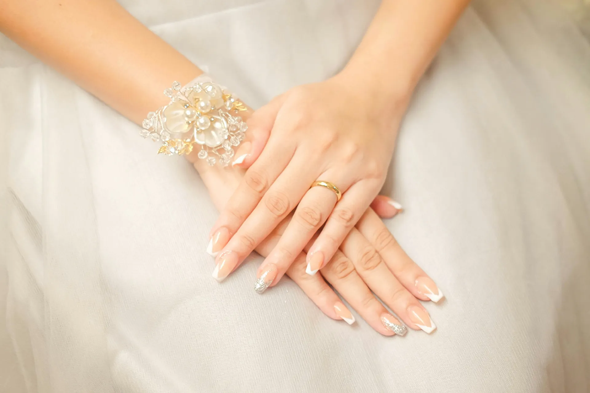 Bride with elegant french manicure wedding nails